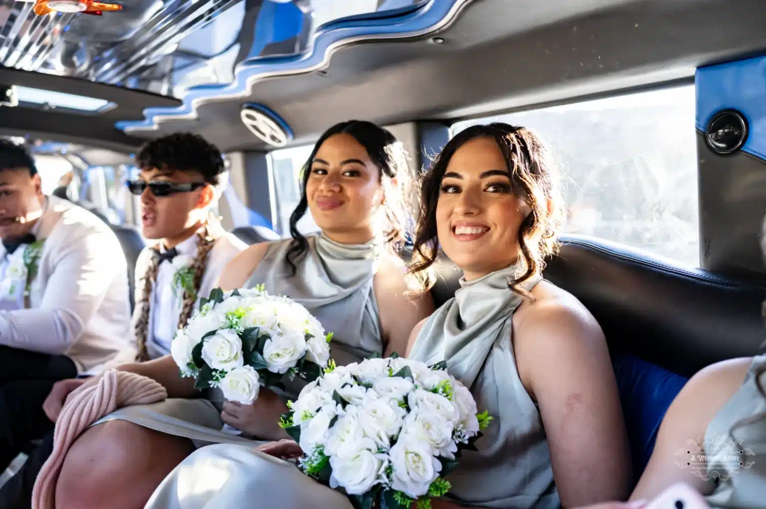 Bridesmaids in elegant sage dresses sit inside a luxurious wedding limousine, holding beautiful white rose bouquets, smiling brightly as they enjoy the wedding celebration.