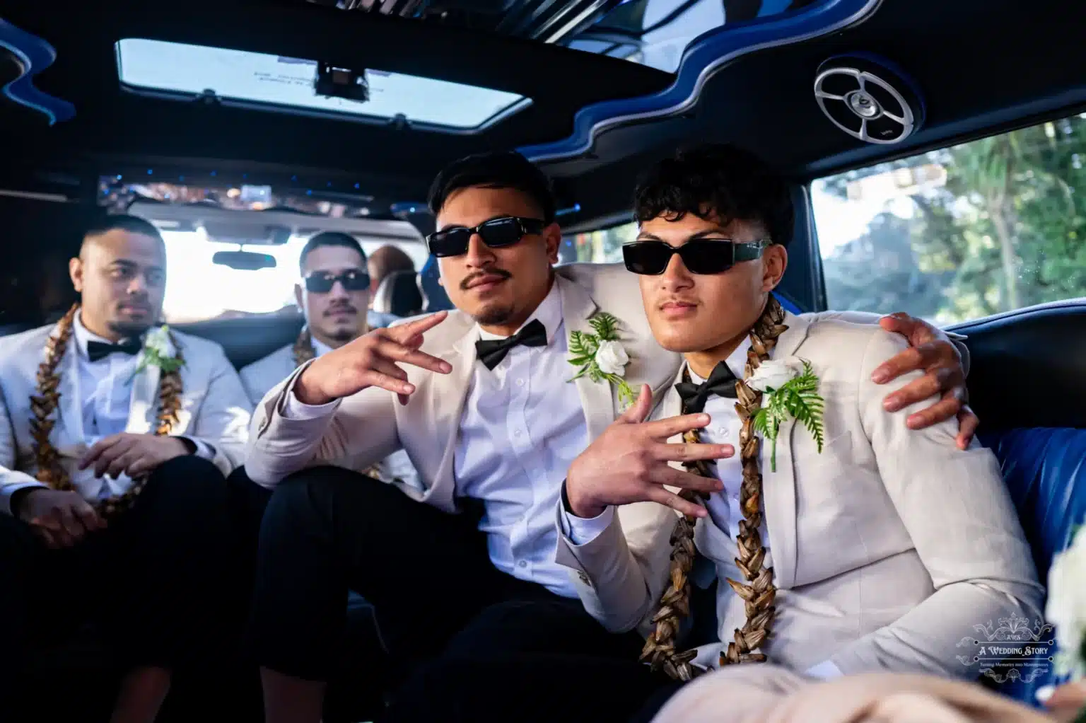 Groomsmen seated inside a limousine, dressed in elegant suits with floral boutonnières, wearing sunglasses, and striking playful poses.