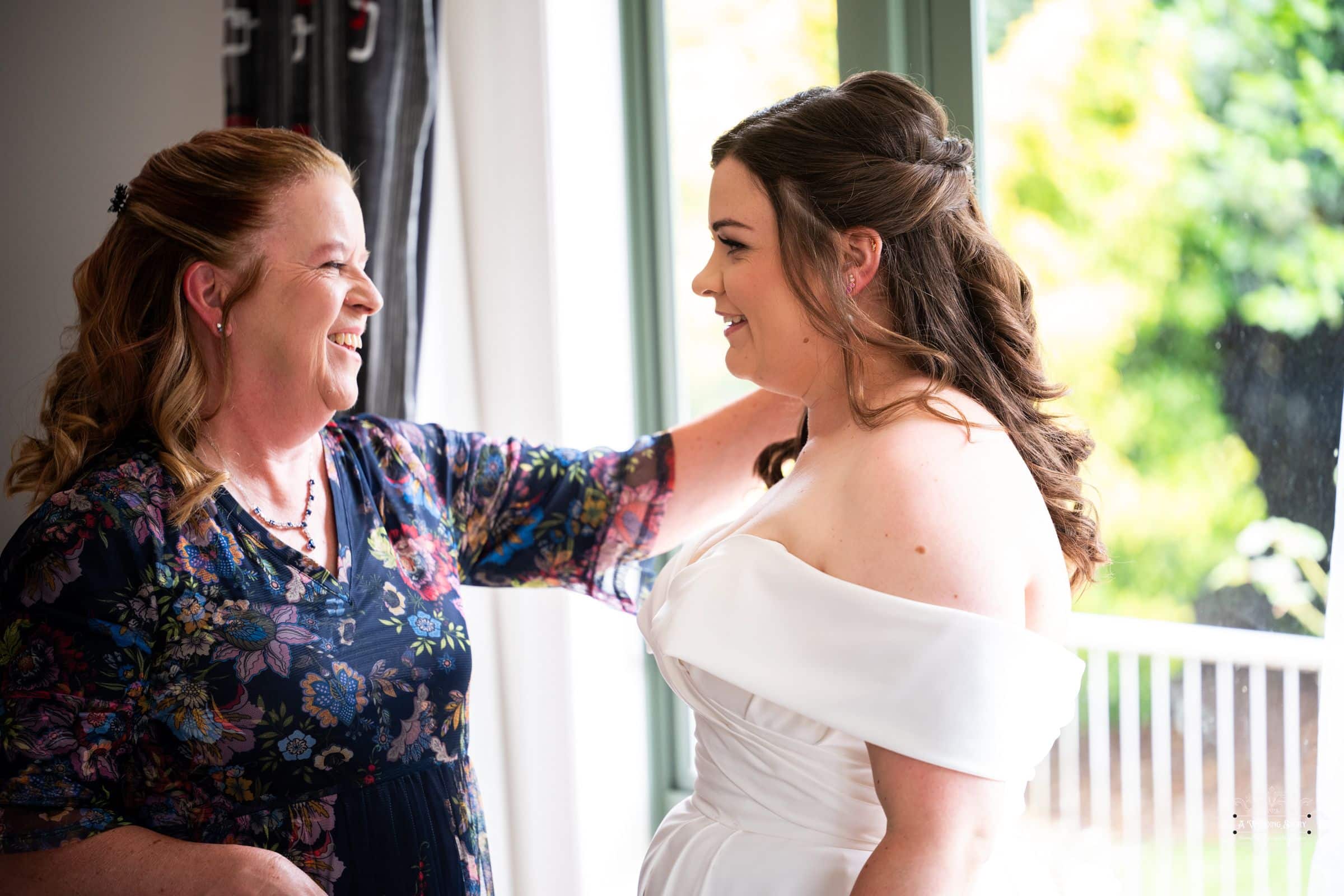 Bride sharing a heartfelt moment with her mother before the wedding at their Carterton home