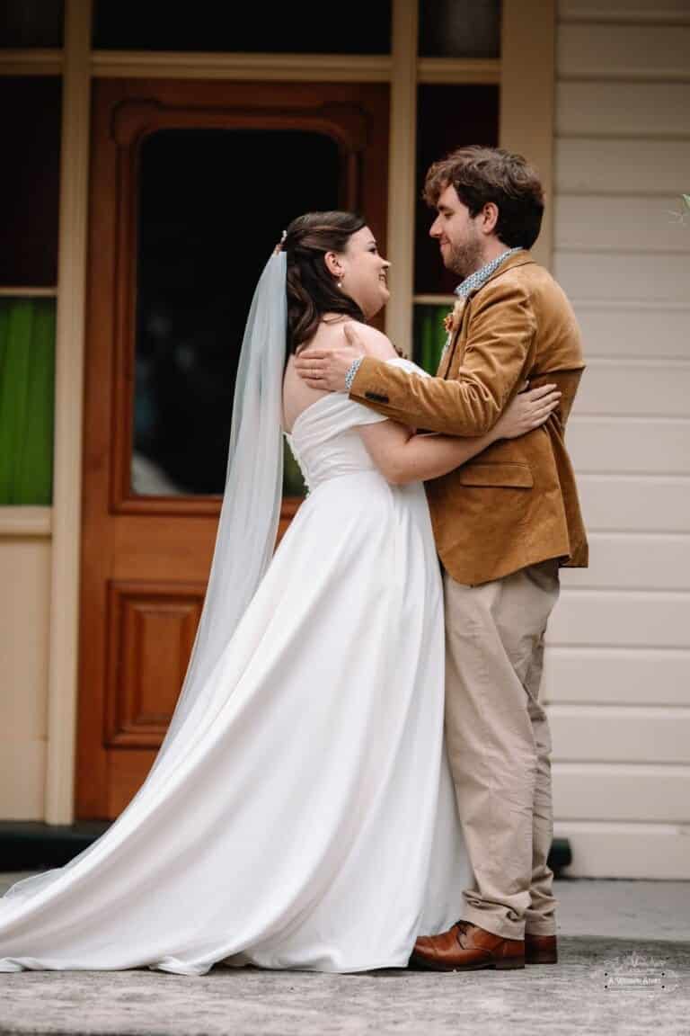 Bride and groom share an intimate embrace after exchanging vows, captured in a candid wedding photography moment