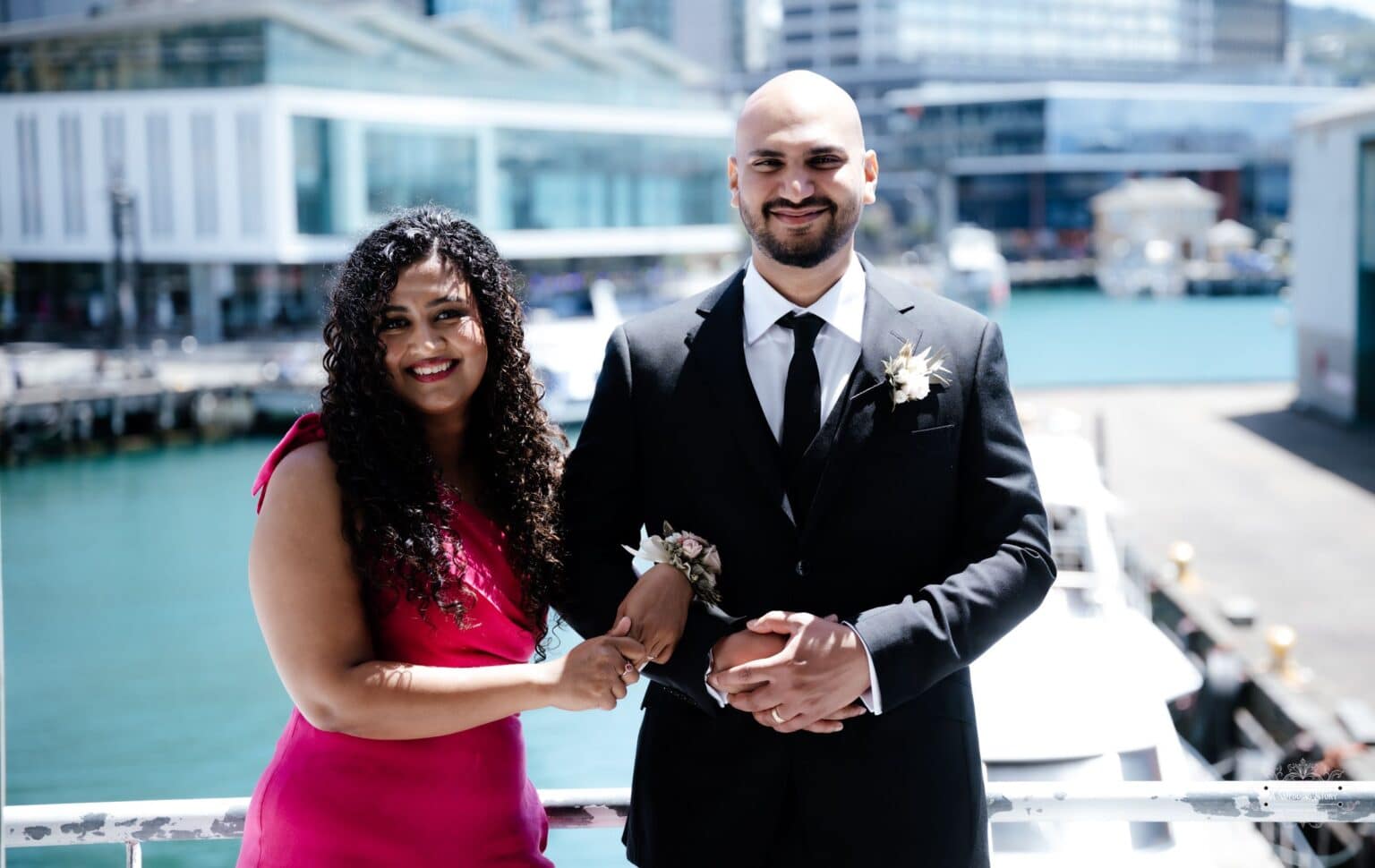 A joyful moment of Chammi and Mark at their dockside wedding in Wellington, captured by A Wedding Story, a premier Wellington wedding photographer.