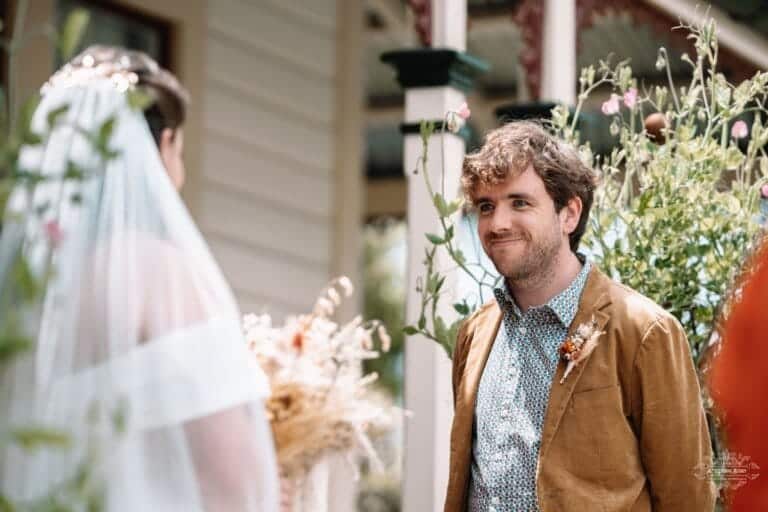 A groom’s emotional reaction as he sees his bride for the first time during the wedding ceremony