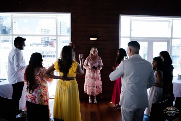 A joyful wedding toast during an intimate ceremony, capturing heartfelt moments of love and celebration, photographed by a Wellington wedding photographer