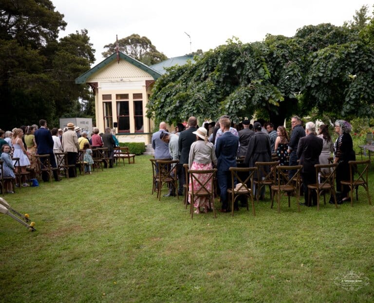 Guests gather for a beautiful outdoor wedding ceremony at a countryside home in Carterton, New Zealand