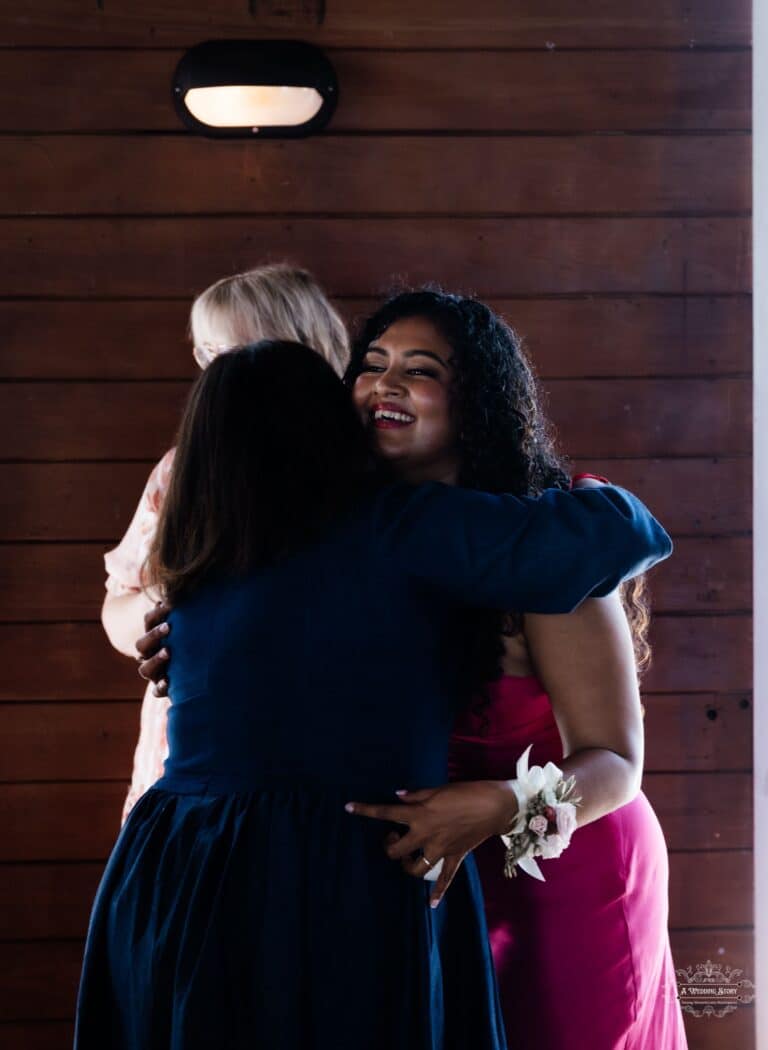 A bride sharing a heartfelt hug with a loved one during an intimate wedding celebration, captured by a Wellington wedding photographer