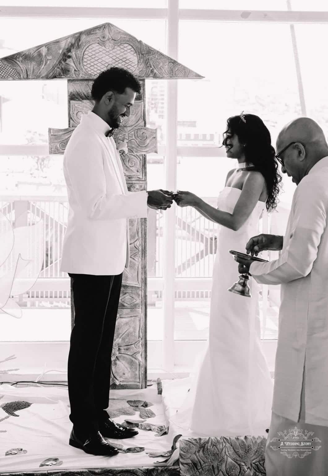 A bride and groom exchange wedding rings in a heartfelt traditional ceremony in Wellington, New Zealand, symbolizing their eternal commitment