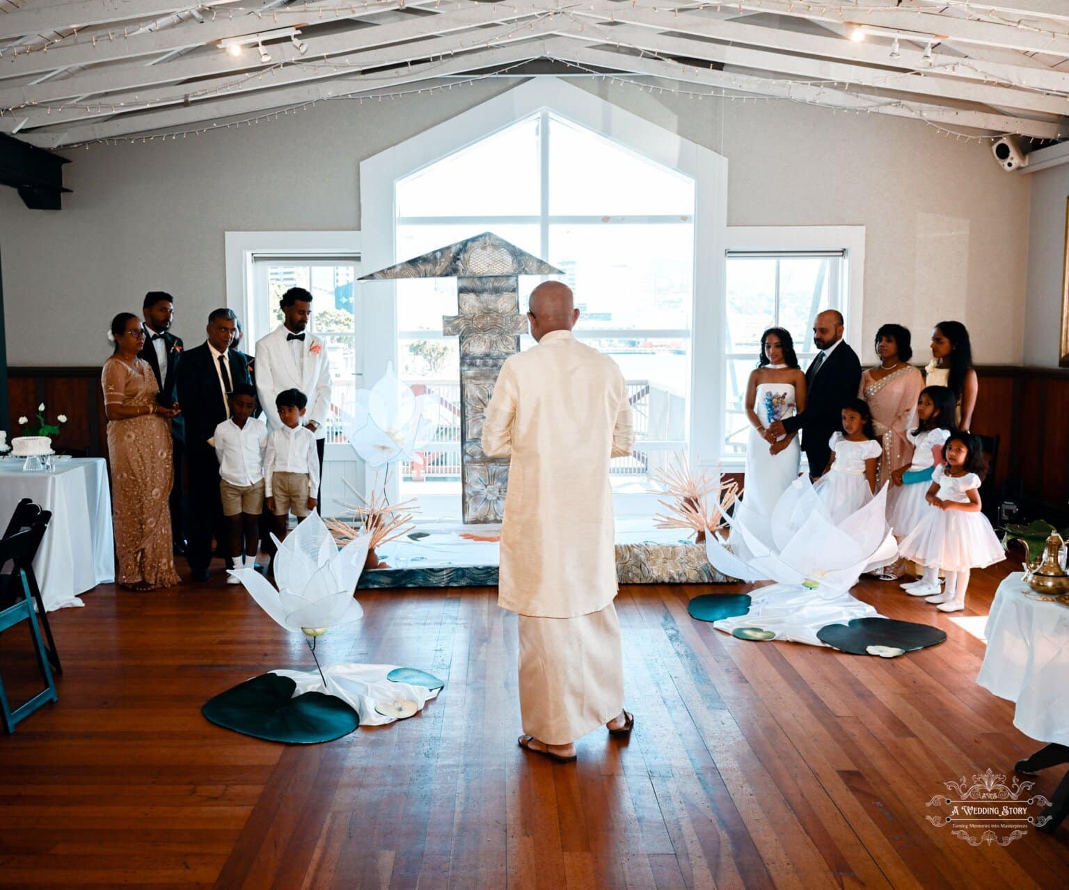 A priest leading a traditional wedding ceremony in Wellington, with the bride, groom, and family members standing in reverence