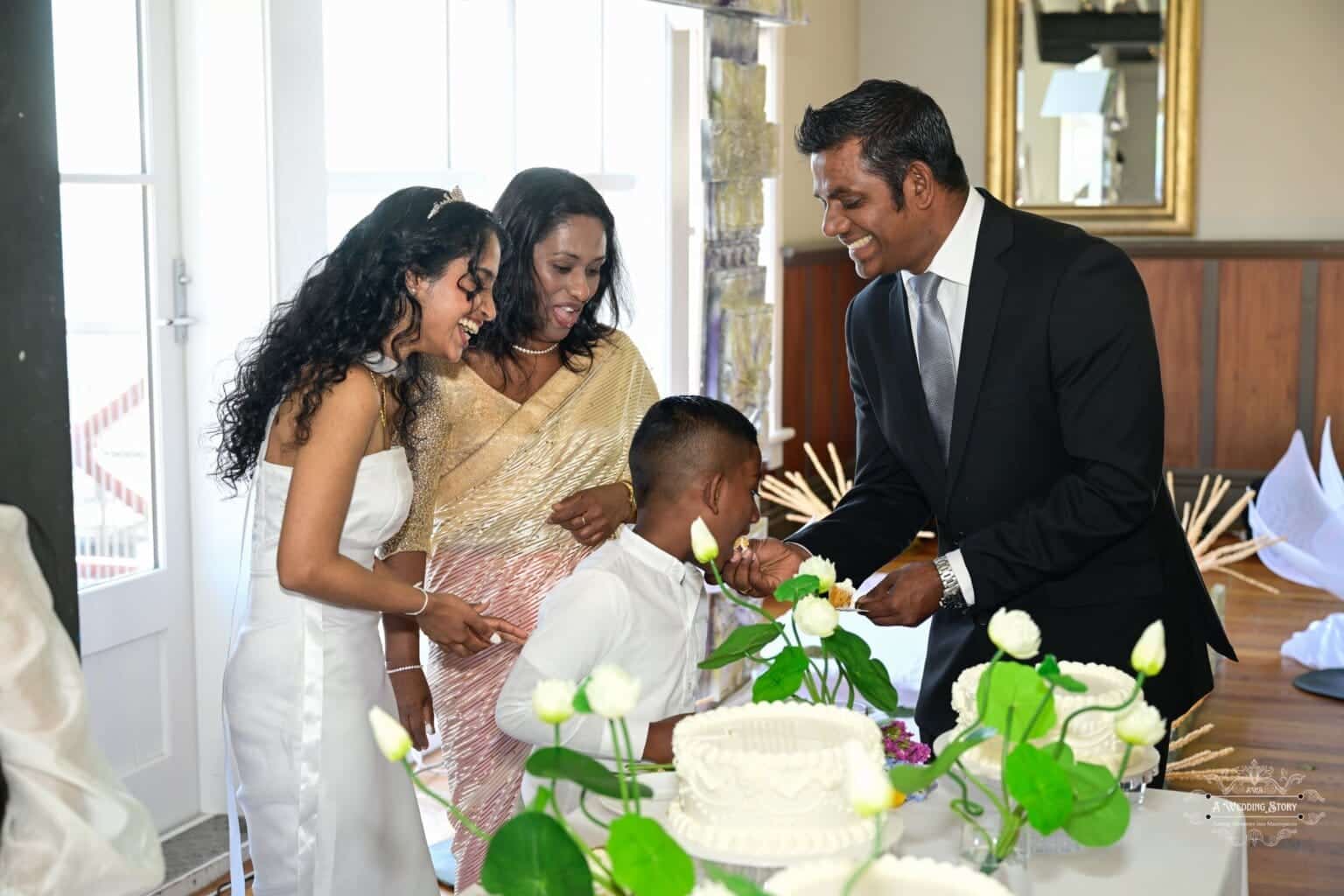 The bride, dressed in an elegant white wedding gown, shares a joyful moment with her family as they celebrate a traditional wedding in Wellington