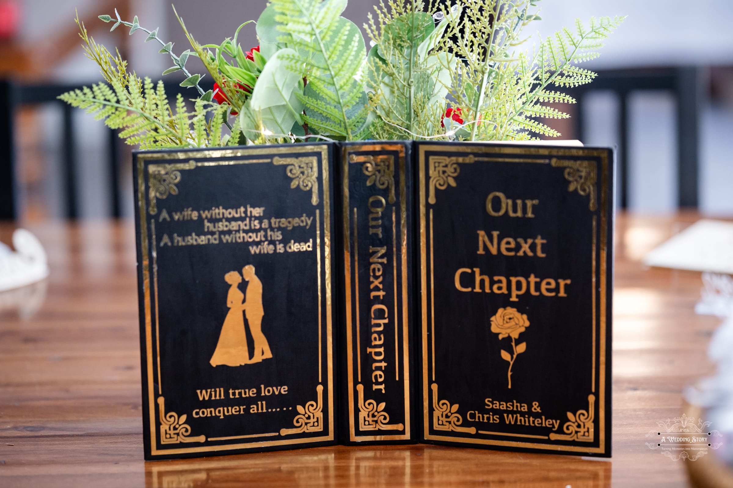 Wedding table decor featuring a book-inspired centerpiece with “Our Next Chapter” message at The Lodge Pāuatahanui Wellington